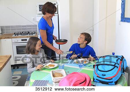 Mother with children at lunch time View Large Photo Image Stock Image - Mother with children at lunch time. Fotosearch