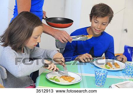 Mother with children at lunch time View Large Photo Image Stock Image - Mother with children at lunch time. Fotosearch
