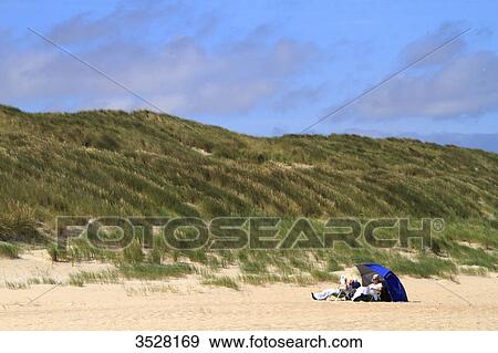 Nederlands. Wadden Islands archipelago. Vlieland island. Retired couple on the beach. View Large Photo Image Stock Photo - Nederlands. Wadden Islands archipelago. Vlieland island. Retired couple on the beach.. Fotosearch