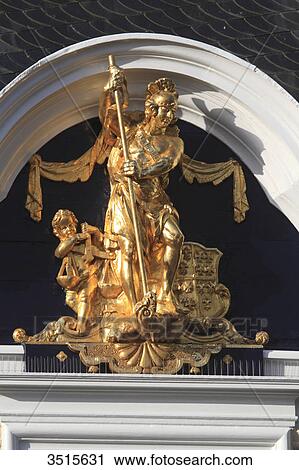 Stock Image - Netherlands, Friesland. Harlingen. Golden statue on the city hall facade.. Fotosearch