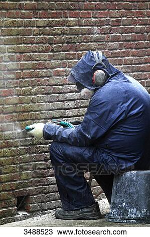 Netherlands, man at work on brick wall View Large Photo Image Stock Image - Netherlands, man at work on brick wall. Fotosearch