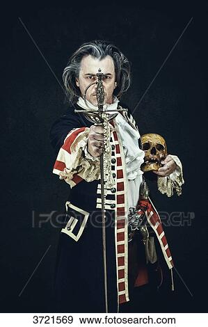 Stock Photo - Officer in uniform dragons, presents his sword facing the camera, a skull under the elbow. Fotosearch