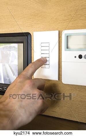 Person pressing switch of a security camera control panel View Large Photo Image Picture - Person pressing switch of a security camera control panel. Fotosearch