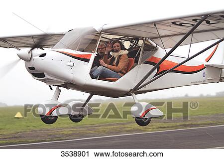 Pilot young woman flying a microlight. View Large Photo Image Stock Image - Pilot young woman flying a microlight.. Fotosearch