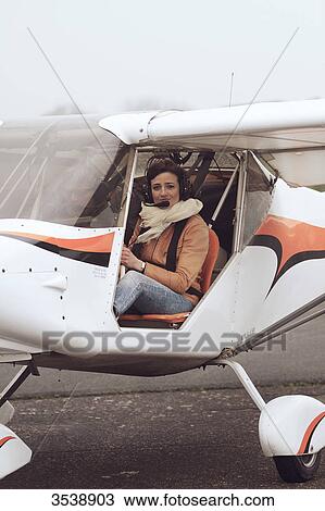 Pilot young woman on board of a microlight on the ground. View Large Photo Image Stock Image - Pilot young woman on board of a microlight on the ground.. Fotosearch