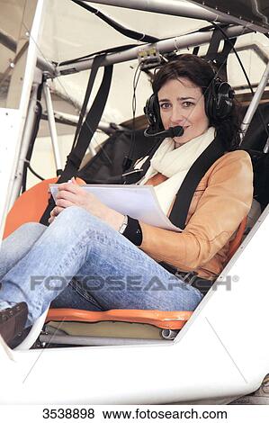 Pilot young woman sitting in the cockpit of her microlight. View Large Photo Image Stock Photo - Pilot young woman sitting in the cockpit of her microlight.. Fotosearch