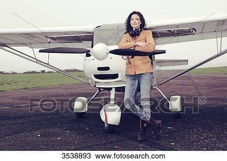 Pilot young woman standing in front of her microlight. View Large Photo Image Stock Image - Pilot young woman standing in front of her microlight.. Fotosearch