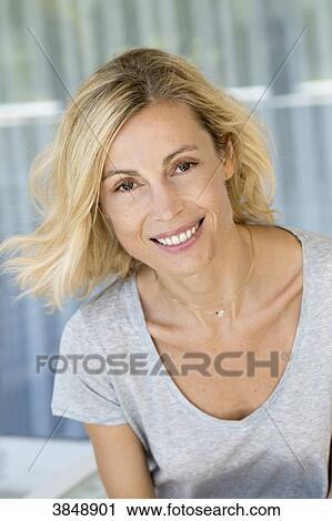 Portrait of a beauty smiling blonde woman with grey tee-shirt. View Large Photo Image Stock Image - Portrait of a beauty smiling blonde woman with grey tee-shirt.. Fotosearch