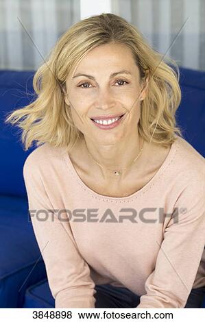 Portrait of a beauty smiling blonde woman with salmon pullover. View Large Photo Image Stock Photo - Portrait of a beauty smiling blonde woman with salmon pullover.. Fotosearch