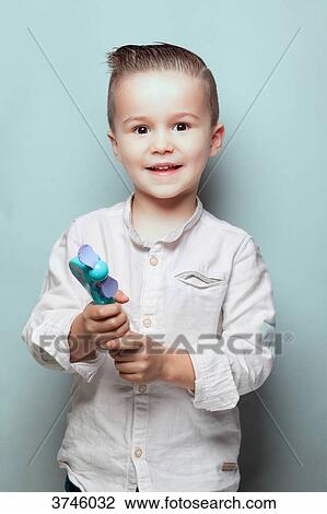 Portrait of a boy, a toy in the hands, eyes toward the goal View Large Photo Image Stock Image - Portrait of a boy, a toy in the hands, eyes toward the goal. Fotosearch