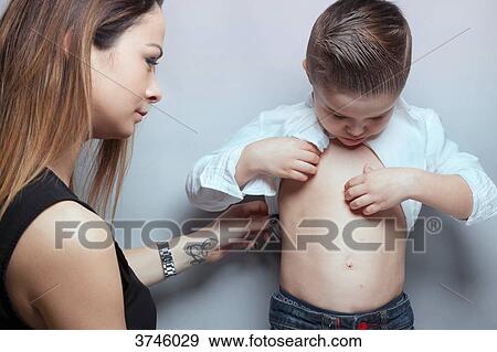 Stock Photo - Portrait of a boy and his mother watching chickenpox button. Fotosearch