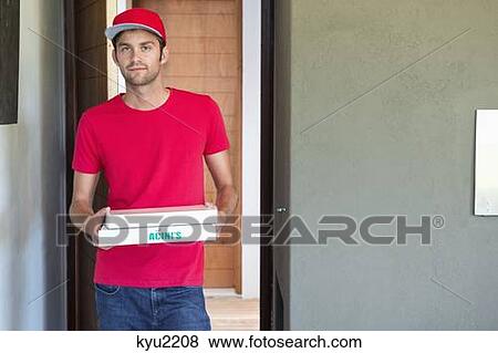 Stock Photo - Portrait of a deliveryman delivering pizza . Fotosearch