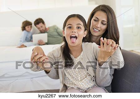 Portrait of a girl sticking her tongue out View Large Photo Image Stock Photo - Portrait of a girl sticking her tongue out. Fotosearch