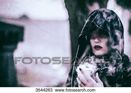 Portrait of a gothic woman holding a chalice View Large Photo Image Stock Image - Portrait of a gothic woman holding a chalice. Fotosearch