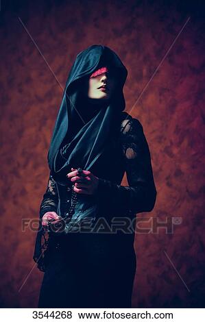 Portrait of a gothic woman holding a rosary View Large Photo Image Stock Photo - Portrait of a gothic woman holding a rosary. Fotosearch