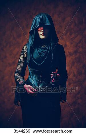 Portrait of a gothic woman holding a rosary View Large Photo Image Stock Photo - Portrait of a gothic woman holding a rosary. Fotosearch