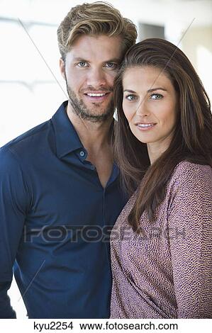 Portrait of a happy couple standing together View Large Photo Image Picture - Portrait of a happy couple standing together. Fotosearch
