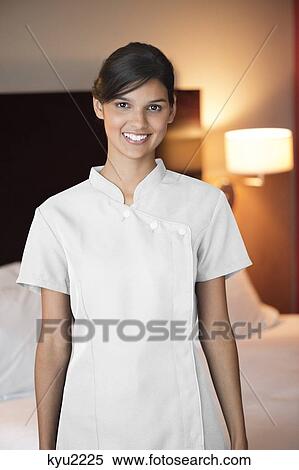 Stock Photography - Portrait of a maid smiling in a hotel room. Fotosearch