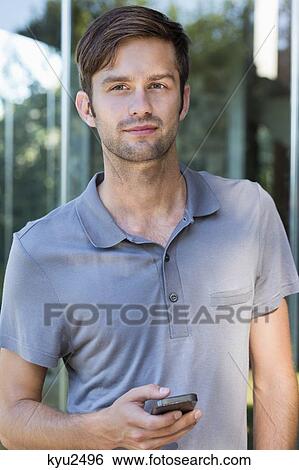Portrait of a man using a mobile phone View Large Photo Image Stock Photograph - Portrait of a man using a mobile phone. Fotosearch