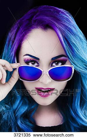 Portrait of a pretty girl lowered her glasses, looking toward the lens View Large Photo Image Stock Photography - Portrait of a pretty girl lowered her glasses, looking toward the lens. Fotosearch