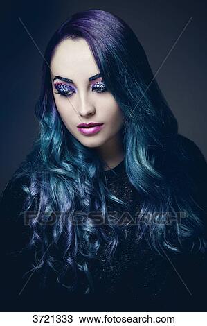 Stock Image - Portrait of a pretty girl with blue hair. Fotosearch