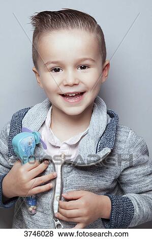 Portrait of a smiling boy toy in hand View Large Photo Image Stock Photo - Portrait of a smiling boy toy in hand. Fotosearch