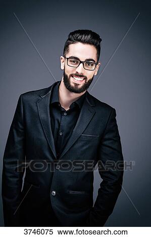 Portrait of a smiling young businessman, looking toward the lens View Large Photo Image Stock Photography - Portrait of a smiling young businessman, looking toward the lens. Fotosearch