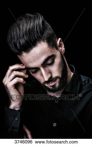 Portrait of a thoughtful young man View Large Photo Image Stock Photograph - Portrait of a thoughtful young man. Fotosearch