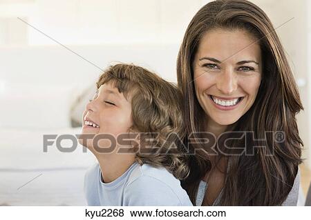 Stock Photo - Portrait of a woman and her son smiling. Fotosearch