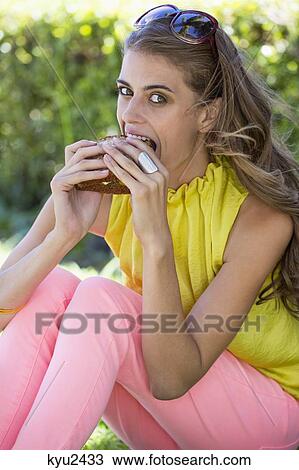Portrait of a woman eating sandwich View Large Photo Image Stock Image - Portrait of a woman eating sandwich. Fotosearch