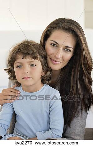 Stock Image - Portrait of a woman smiling with her son. Fotosearch
