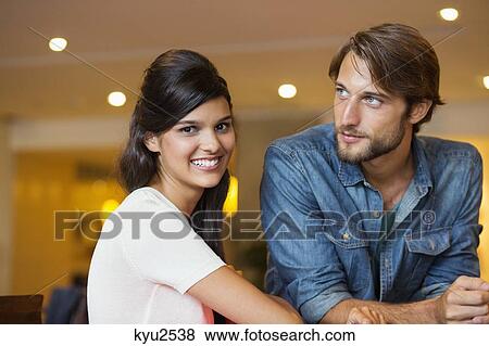 Stock Photo - Portrait of a woman smiling with her friend beside her. Fotosearch