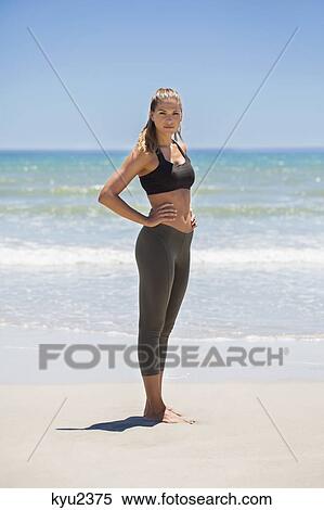 Stock Photography - Portrait of a woman standing on the beach. Fotosearch