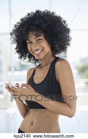 Portrait of a woman using a mobile phone View Large Photo Image Stock Image - Portrait of a woman using a mobile phone. Fotosearch