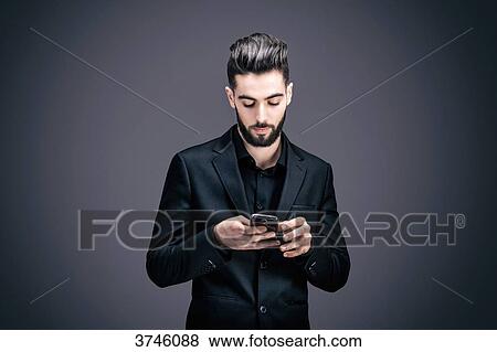 Portrait of a young businessman writing a text message View Large Photo Image Stock Photo - Portrait of a young businessman writing a text message. Fotosearch