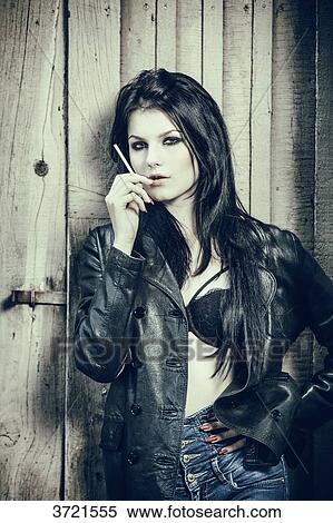 Portrait of a young girl Grunge smoking a cigarette View Large Photo Image Stock Photography - Portrait of a young girl Grunge smoking a cigarette. Fotosearch