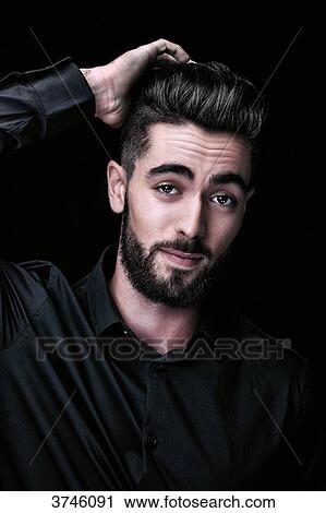 Portrait of a young man, one hand behind his head View Large Photo Image Stock Image - Portrait of a young man, one hand behind his head. Fotosearch