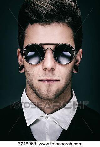 Portrait of a Young man with sunglasses View Large Photo Image Stock Photo - Portrait of a Young man with sunglasses. Fotosearch