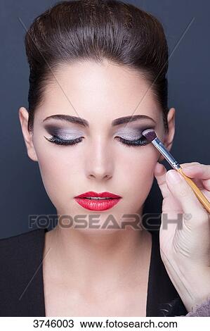 Portrait of a young woman doing makeup, eyes closed View Large Photo Image Stock Image - Portrait of a young woman doing makeup, eyes closed. Fotosearch