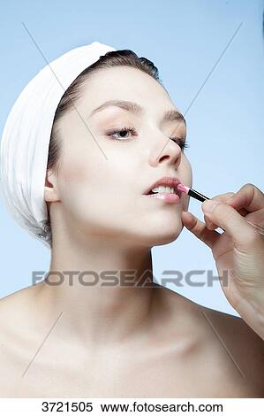 Portrait of a young woman doing makeup lips View Large Photo Image Stock Photography - Portrait of a young woman doing makeup lips. Fotosearch