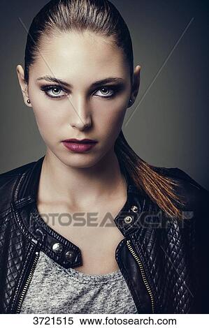 Portrait of a young woman hair pulled, face, eyes toward the lens View Large Photo Image Stock Photography - Portrait of a young woman hair pulled, face, eyes toward the lens. Fotosearch