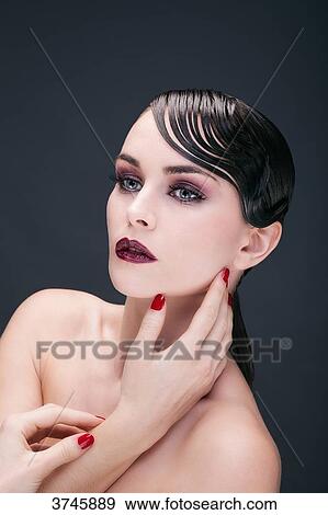 Portrait of a young woman, hand on cheek View Large Photo Image Stock Photo - Portrait of a young woman, hand on cheek. Fotosearch