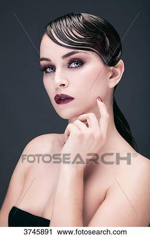 Portrait of a young woman, hand on chin View Large Photo Image Stock Image - Portrait of a young woman, hand on chin. Fotosearch