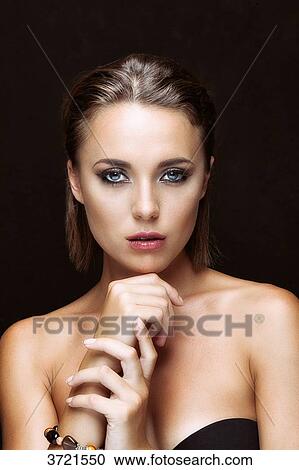 Portrait of a young woman hand on his chin looks lens View Large Photo Image Stock Image - Portrait of a young woman hand on his chin looks lens. Fotosearch