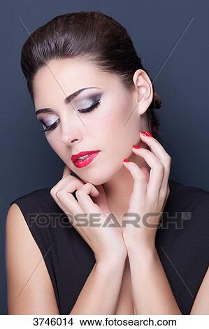 Portrait of a young woman, hand under chin, looking down View Large Photo Image Picture - Portrait of a young woman, hand under chin, looking down. Fotosearch