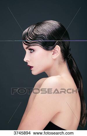 Portrait of a young woman in profile, arms along the body View Large Photo Image Picture - Portrait of a young woman in profile, arms along the body. Fotosearch