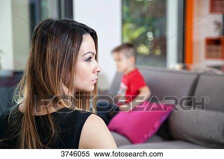 Portrait of a young woman in profile, her son in the background View Large Photo Image Stock Photography - Portrait of a young woman in profile, her son in the background. Fotosearch