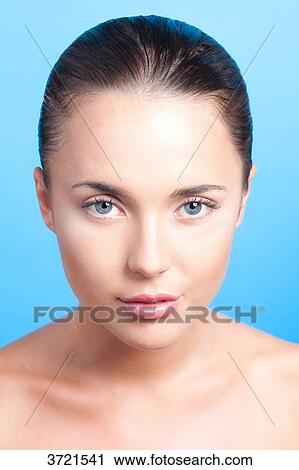 Portrait of a young woman looking at camera View Large Photo Image Stock Image - Portrait of a young woman looking at camera. Fotosearch