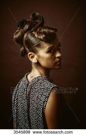 Stock Photo - Portrait of a young woman looking at camera. Fotosearch
