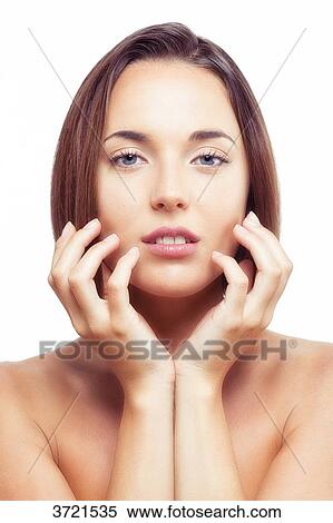 Portrait of a young woman looking at camera, hand on chin View Large Photo Image Stock Photography - Portrait of a young woman looking at camera, hand on chin. Fotosearch